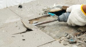 Dustless tile removal in progress in a Brisbane bathroom with dust extraction equipment